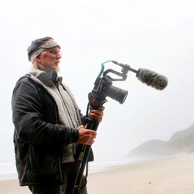 Kurt Williams uses a camera to document the foggy Oregon coast