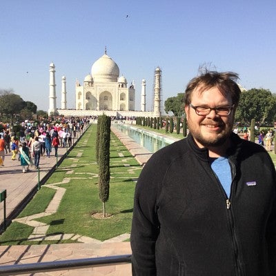 Patric Jones standing by the Taj Mahal