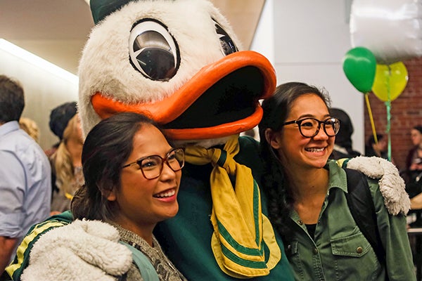 Two female students smiling with the Duck