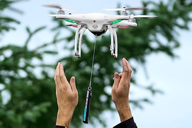 Two hands releasing a drone. 