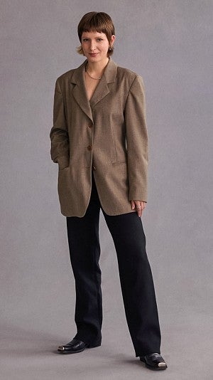 Claren Walker poses for a portrait wearing a brown suit jacket