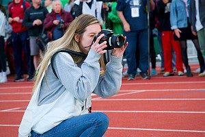 a student shoots photos at Hayward Field