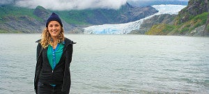 Maia Laperle poses in front of a glacier in Alaska