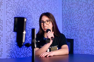 a student uses the SOJC podcast studio
