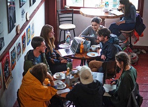 SOJC Science and Memory students meet around small tables in the Whale's Tale cafe in Cordova, Alaska