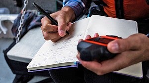 Person taking notes in a notebook