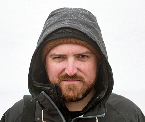 Jeff Dean Jeff Dean wears a hooded black goat with a background of snow