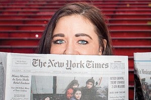 New York Times editor holding newspaper