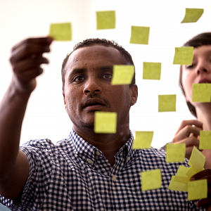 Student adding post-it notes to screen