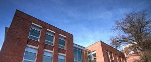 the top of Allen Hall in front of a blue sky