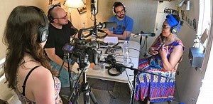 three students record audio and video footage of a community member three students record audio and video footage of a community member
