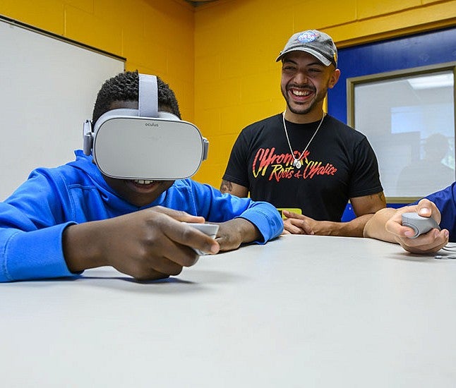 Danny Pimentel works with a student wearing a VR headset Danny Pimentel works with a student wearing a VR headset