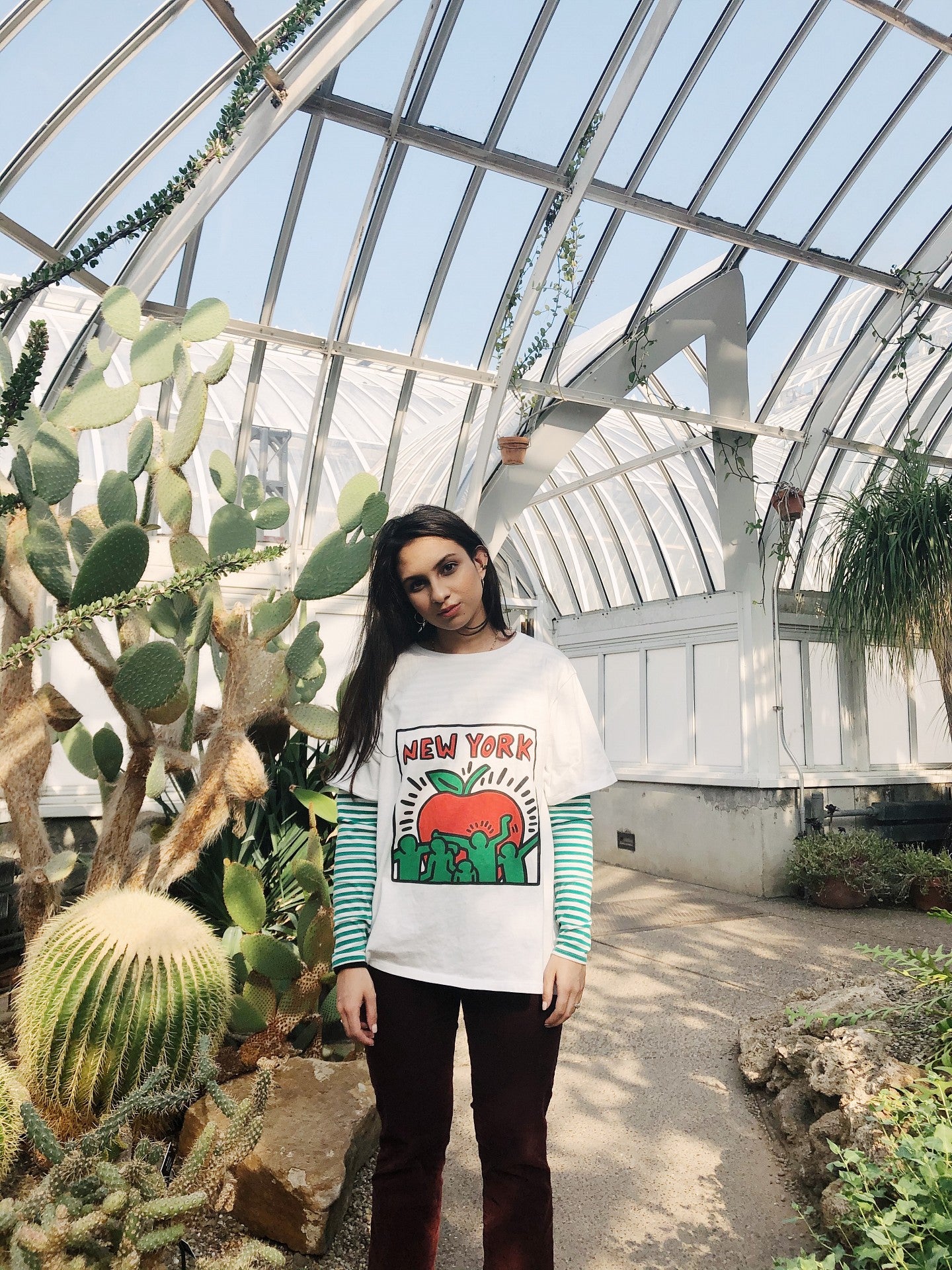 Zaria Parvez strikes a pose in a large greenhouse.