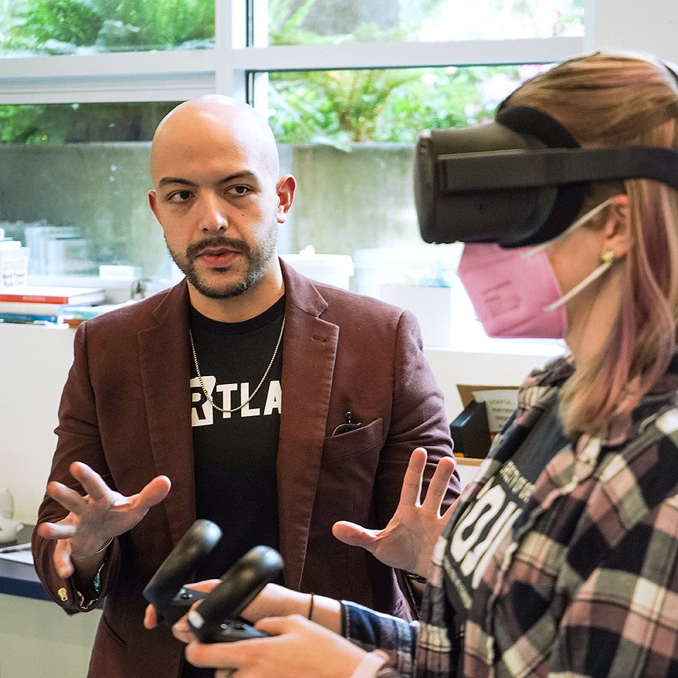 Danny Pimentel instructs a student wearing a VR headset