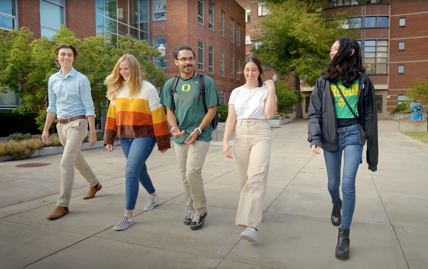 a group of SOJC students walk in front of Allen Hall