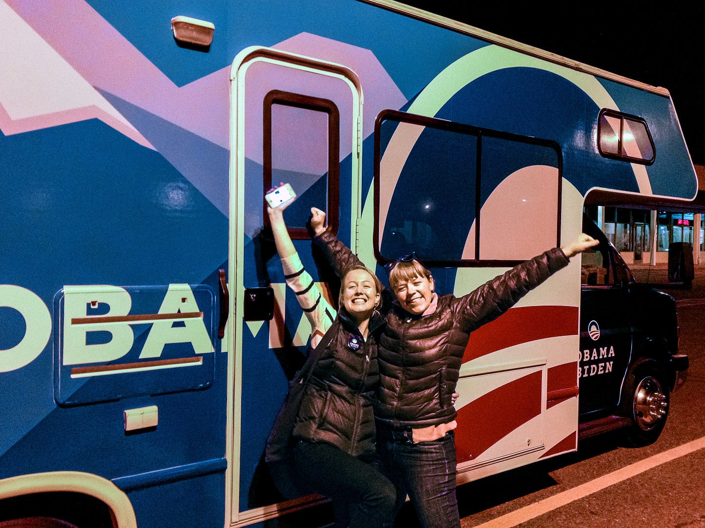 Serena Woods and a colleague in front of an Obama bus