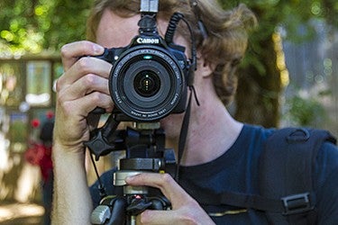 Person taking photograph with Canon camera. Person taking photograph with Canon camera.