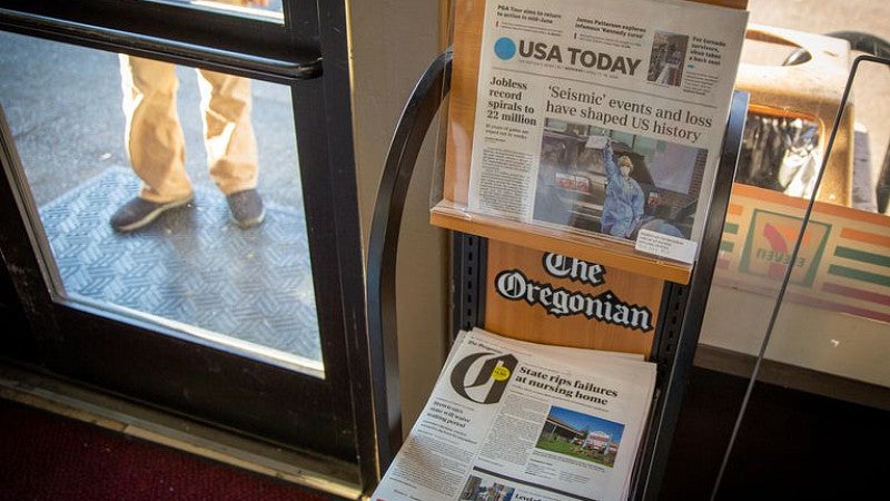 USA Today and The Oregonian newspapers on stands in Portland