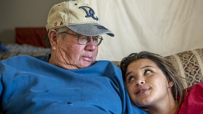 Shayanna Campbell looks lovingly up at her grandfather Skinny