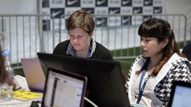Shontz assists Track Class student Romaine Soh ’17 in the press tent at the 2016 U.S. Olympic Trials. Shontz assists Track Class student Romaine Soh ’17 in the press tent at the 2016 U.S. Olympic Trials.