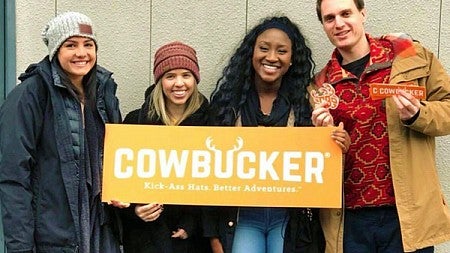 Allen Hall public relations students holding Cowbucker sign Allen Hall public relations students holding Cowbucker sign