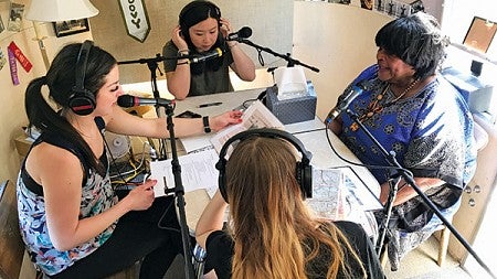 Students sitting a table recording an interview with a resident of Vanport Students sitting a table recording an interview with a resident of Vanport