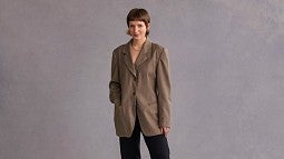 Claren Walker poses for a portrait wearing a brown suit jacket