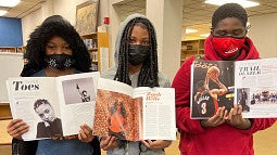 Three Black students pose with the new Black Student Magazine