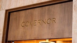 A sign over a doorway that reads, "Governor."