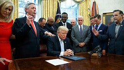 Religious leaders pray with then President Donald Trump after he signed a proclamation for a national day of prayer to occur on Sunday, Sept. 3, 2017. Evan Vucci / AP file