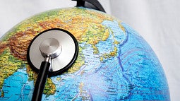 a stethoscope placed on a globe