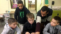 Teacher helping middle school students