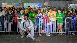 Kayvon with kids and fans at an event