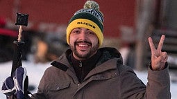 Danny Pimentel, Assistant Professor of Immersive Psychology, outside on a snowy day holding a camera