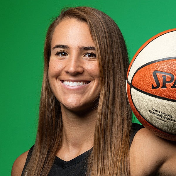Sabrina Ionescu holds a basketball