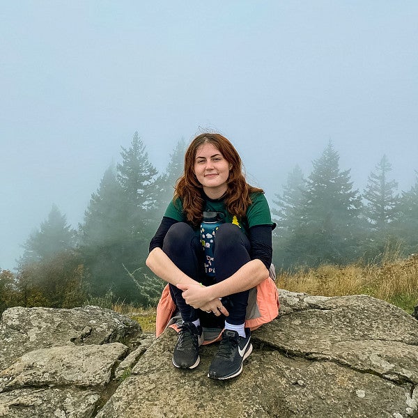 Ella Norton sits at the summit of Spencer Butte in Eugene